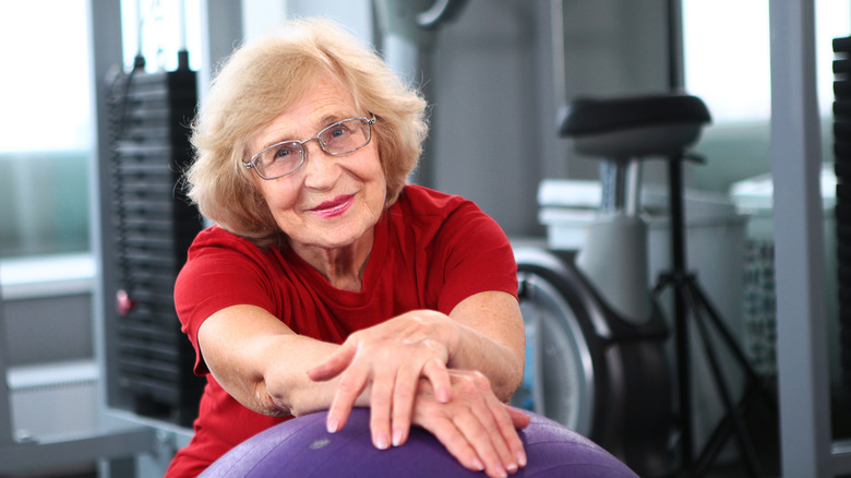 senior gymgoer in front of exercise equipment