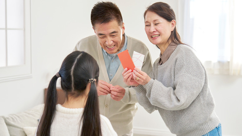 grandparents giving gift to grandchild