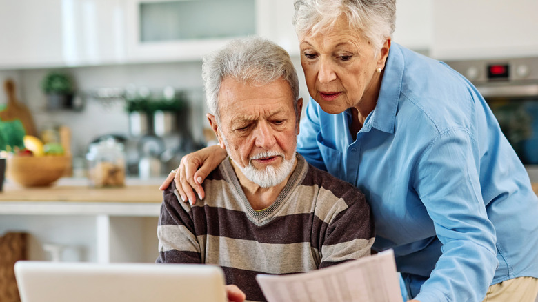 retired couple looking at documents