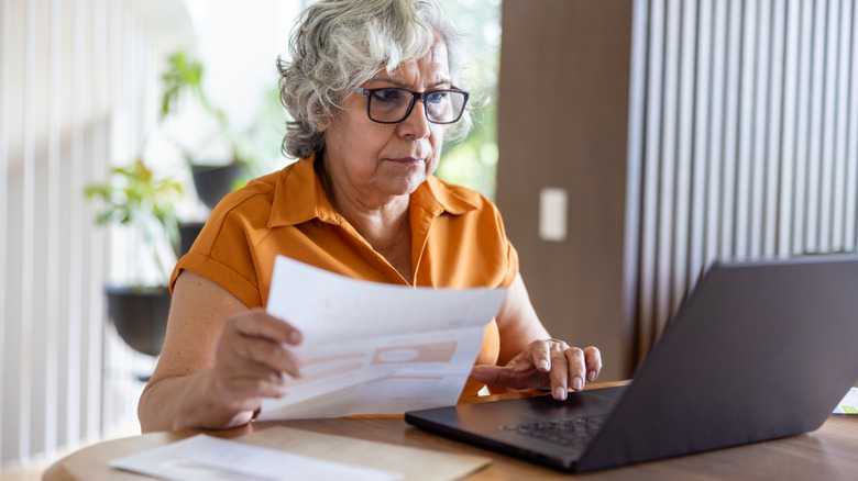 senior looking at utility bill