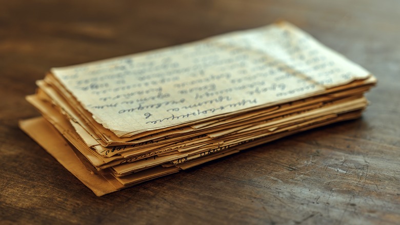 A slightly burred image of a stack of very old handwritten letters