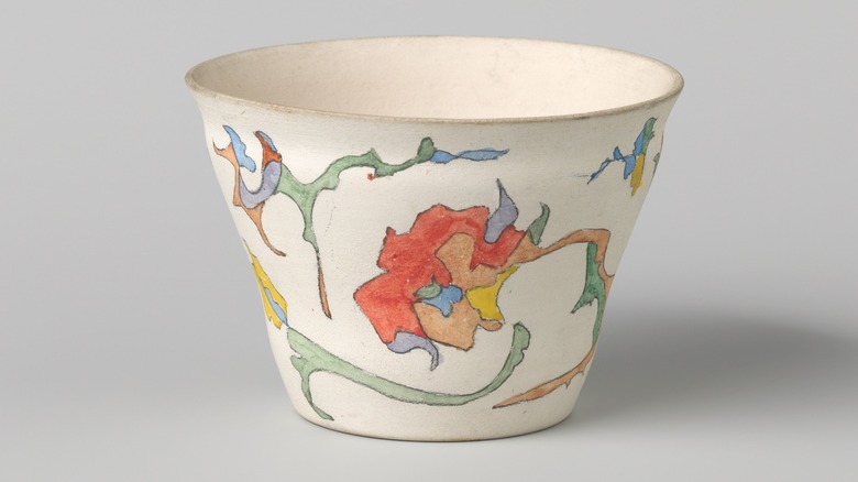 Early 20th century unglazed white pottery with colorful drawings