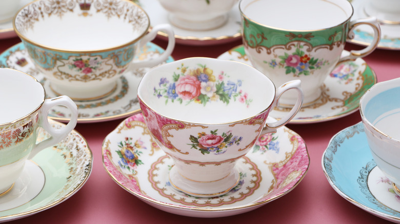Collection of China tea cups sitting on plates