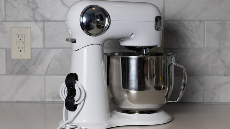 A stand mixer resting on a kitchen counter