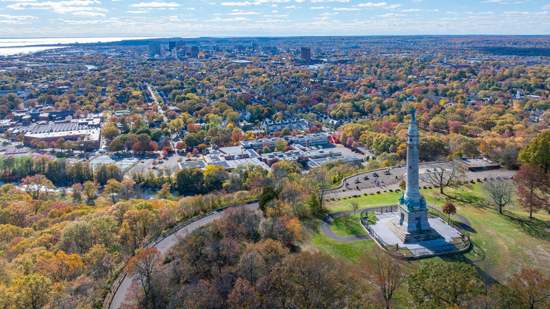 Drone angle view of New Haven, CT from East Rock Park with monument, fall colors and city skyline.