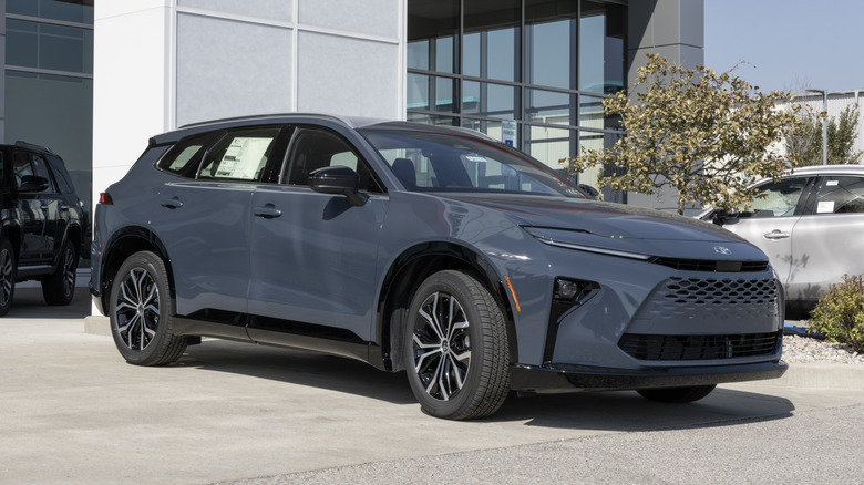 A dark grey Toyota Crown Signia on display outside at a dealership.