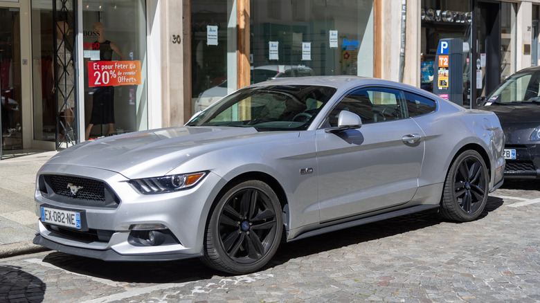 a grey Ford Mustang GT parked on a street.