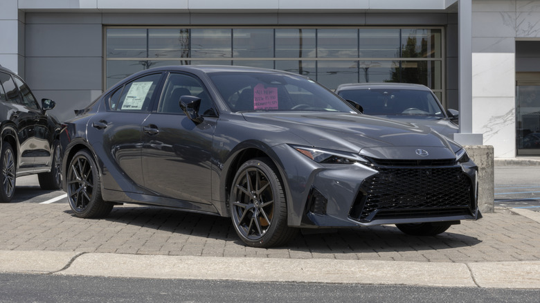 Lexus IS 350 F Sport Design AWD sedan display at a dealership.