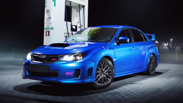 Blue car Subaru Impreza WRX STI stay on fuel station in city Moscow at night