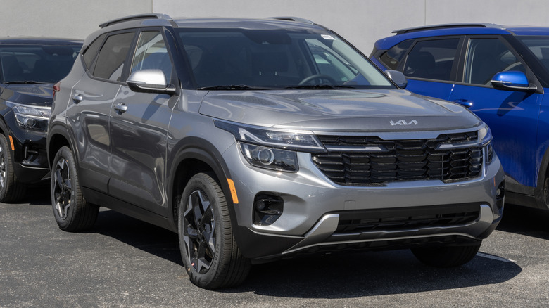 A silver Kia Seltos S AWD Compact SUV at a dealership.