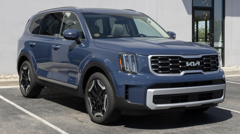A blue Kia Telluride S V6 FWD 8-seat SUV at a dealership