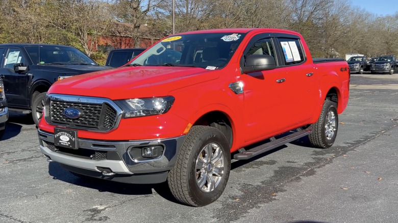 A red Ford Ranger XLT on display outside of a dealership