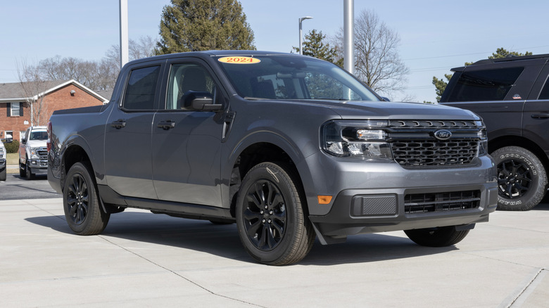 A gray 2024 Ford Maverick XLT on display at a dealership.