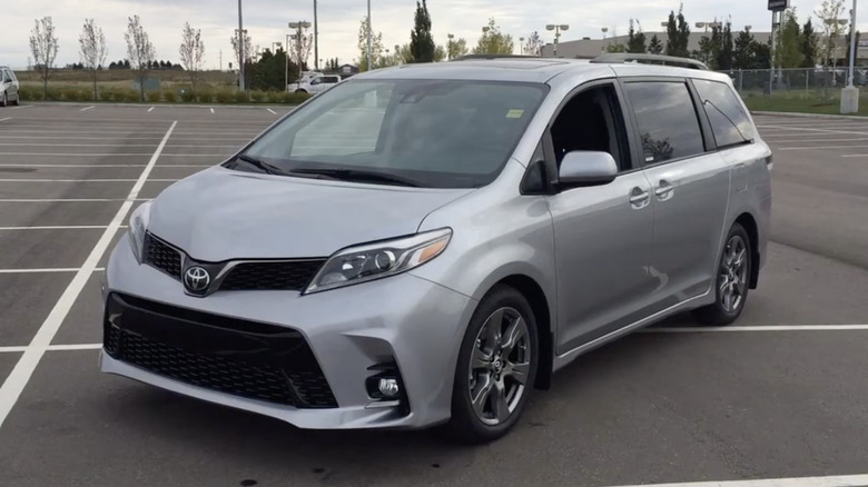 A silver 2018 Toyota Sienna in a mostly empty parking lot