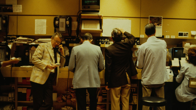 A vintage photograph of stock brokers from the 1980s.