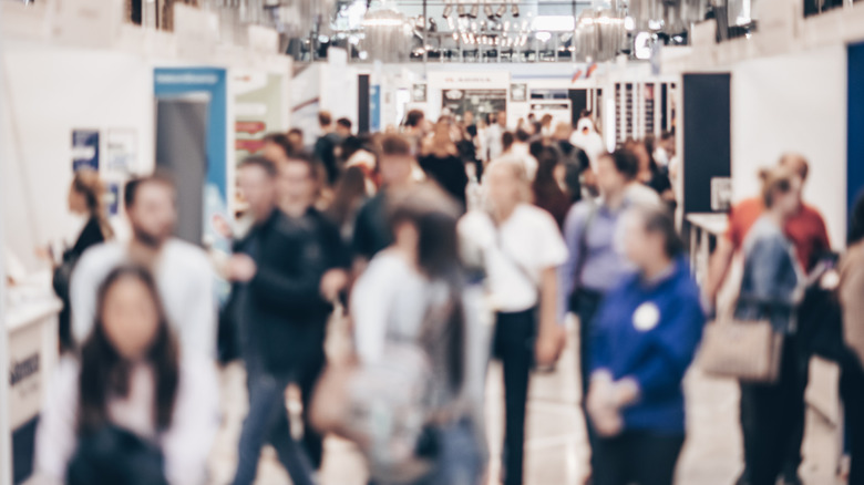 Dozens of people walking around a job fair