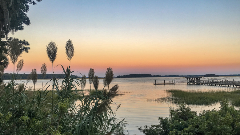 Beautiful lake ar sunset with pier in the distance