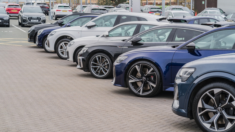 A row of Audis at a dealership in England.