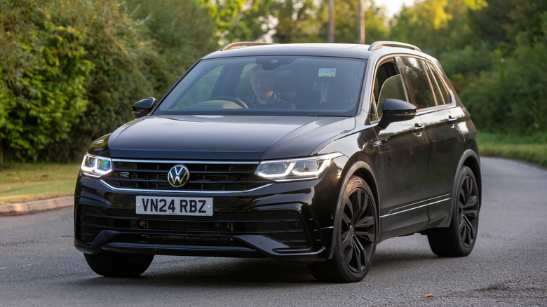 Volkswagen Tiguan car driving on a British country road.