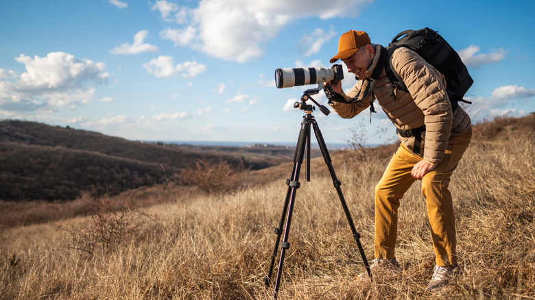 wildlife senior photographer taking photo with tripod