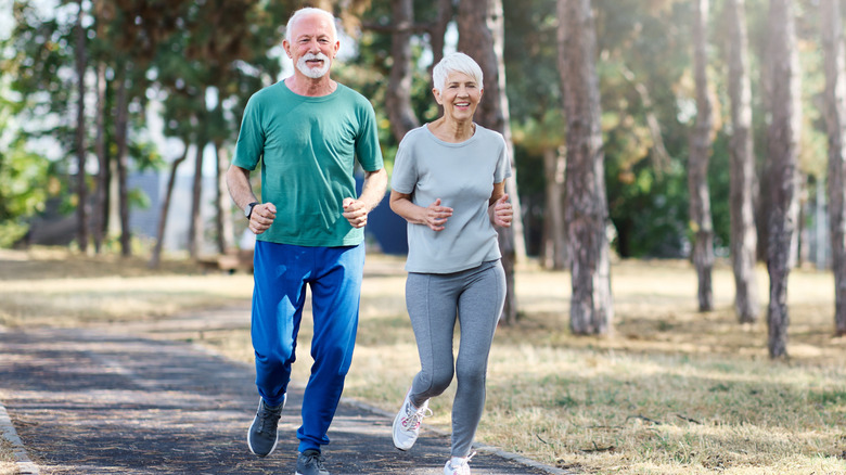 seniors couple running in park