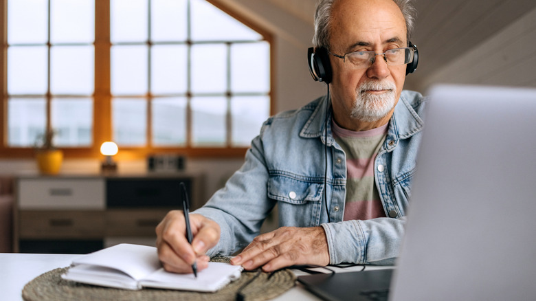 older man writing