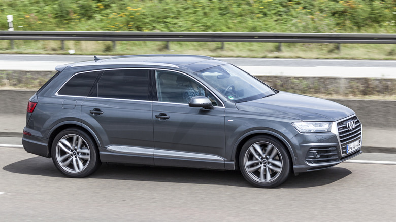 AUDI Q7 luxury SUV driving on the highway