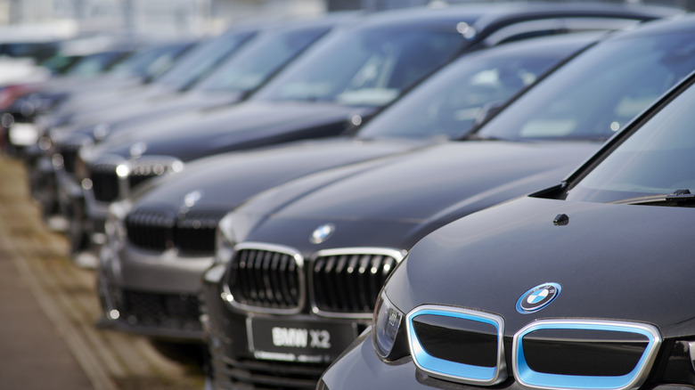 Row of BMW cars at dealership.