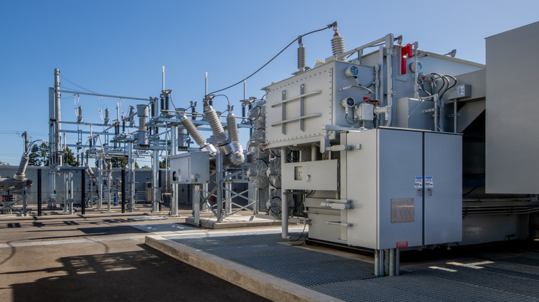 Electrical substation with breakers, transformers, and switching gear.