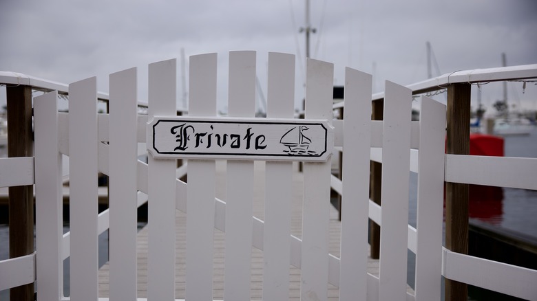 Picket fence with the word "private" and a tiny ship drawn on it