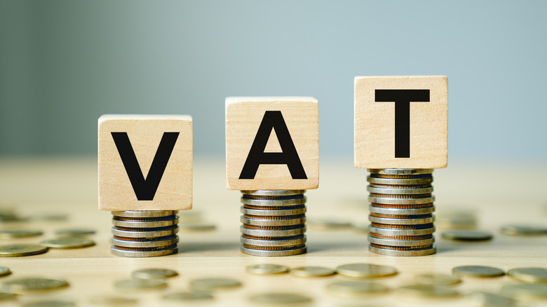 VAT symbol or value added tax on wooden blocks with coins