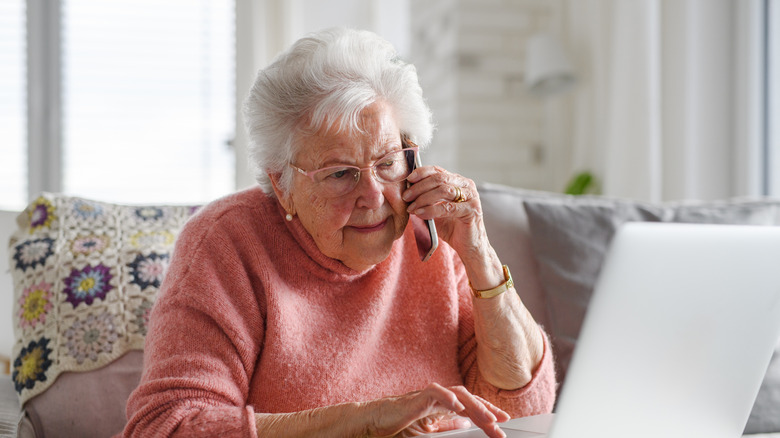 Senior woman working with laptop, shopping online, making call.