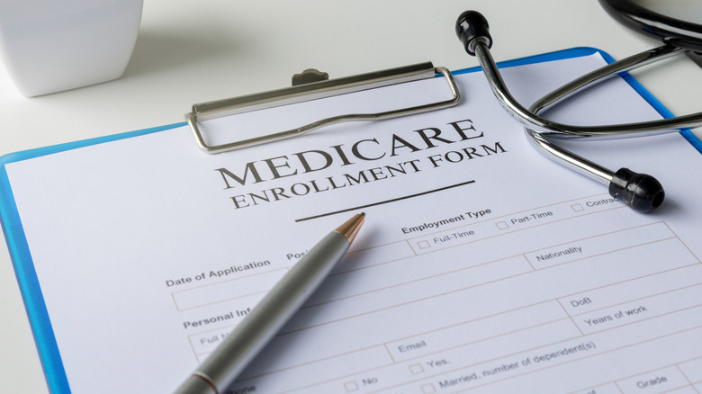 Medicare enrollment form with pen and doctor's stethoscope