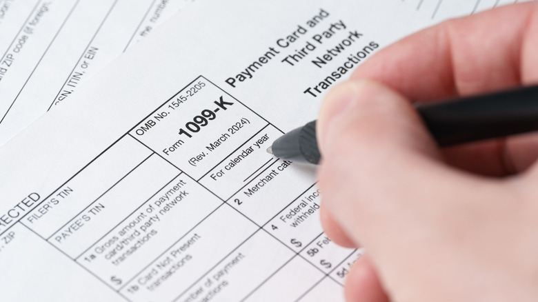 person filling a tax form