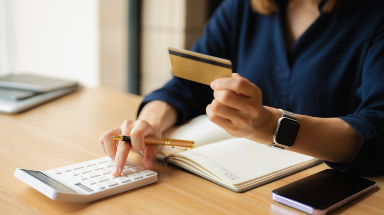 person calculating business expenses