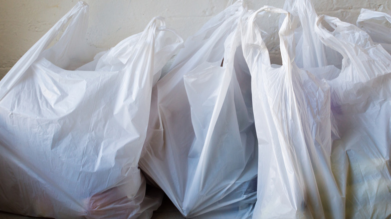 A group of plastic shopping bags on a floor