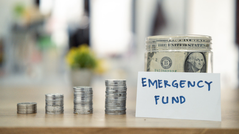 money stacked up with emergency fund written on a card