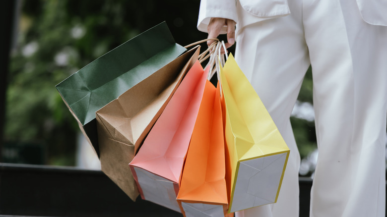 person holding lots of shopping bags