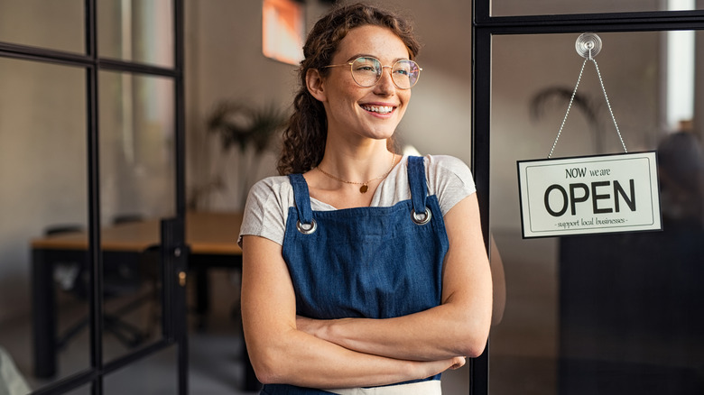 woman standing in open shop door