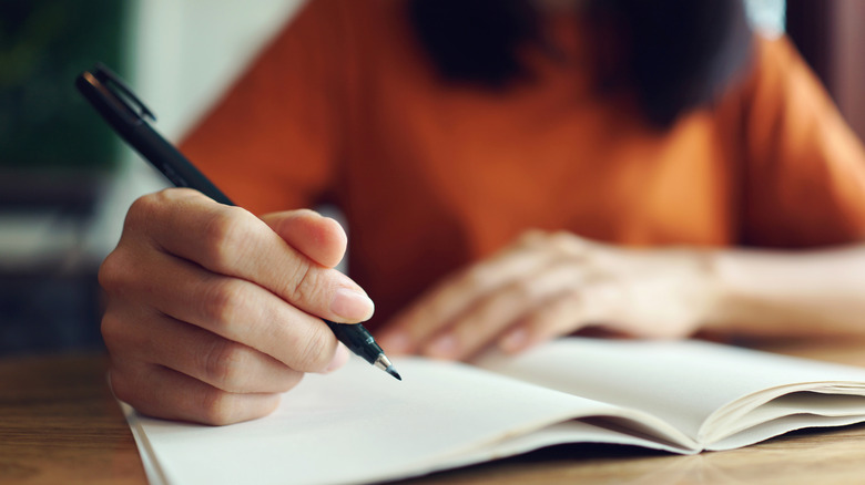 a woman writing down her plan