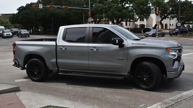 A grey and black Chevy Silverado 1500 pick-up truck cruising near Herman Park in Houston.