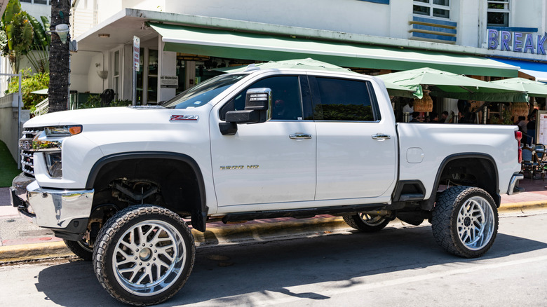 A white 2025 Chevrolet Silverado 2500HD parked on the street.