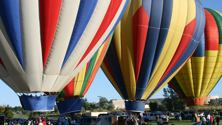 three hot air balloons ready for takeoff
