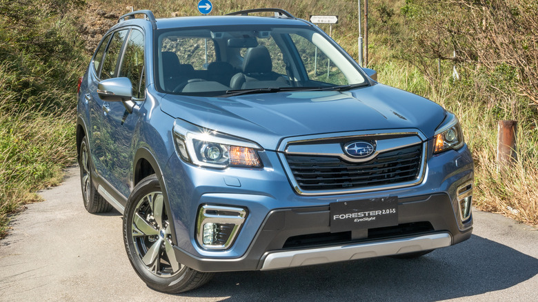 A blue Subaru Forester parked on a trail