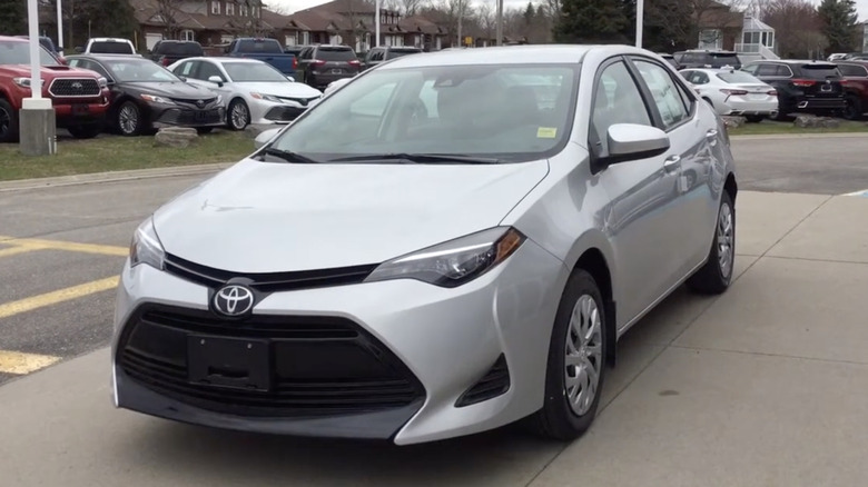 A silver 2019 Toyota Corolla parked on a sidewalk