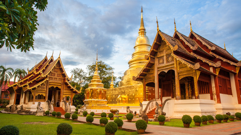 The lavish gold exterior of a Buddhist temple in Chiang Mai, Thailand