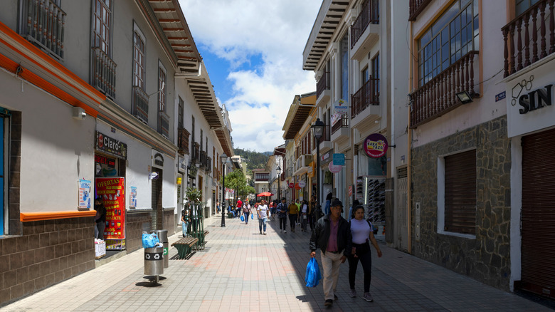 Locals walking in the pedestrian zone in  Loja, Ecuador on a sunny day