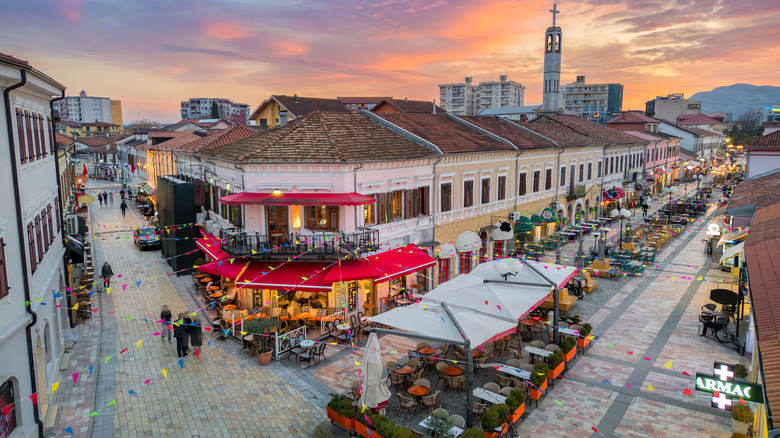 An aerial view of people walking the main streets of Shkodër, Albania at dusk