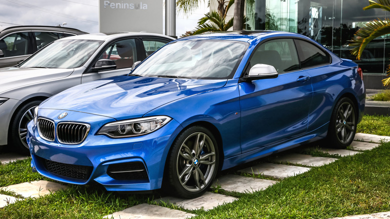 A blue BMW 2-Series on display.