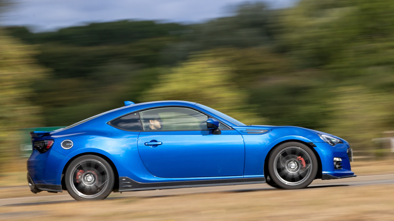 Blue Subaru BRZ driving down the road.